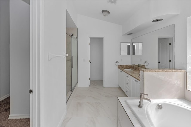 bathroom with vanity, lofted ceiling, and independent shower and bath