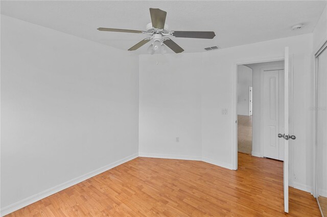 empty room featuring ceiling fan and light hardwood / wood-style floors