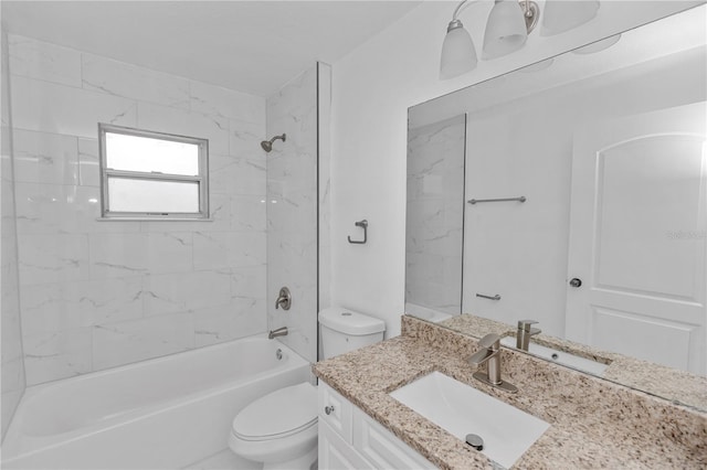 full bathroom with vanity, toilet, and tiled shower / bath