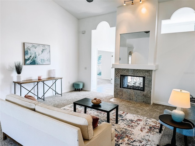 living room featuring a multi sided fireplace and light colored carpet