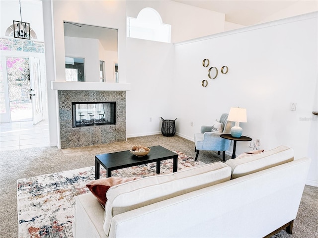 living room featuring a multi sided fireplace, carpet floors, and a high ceiling