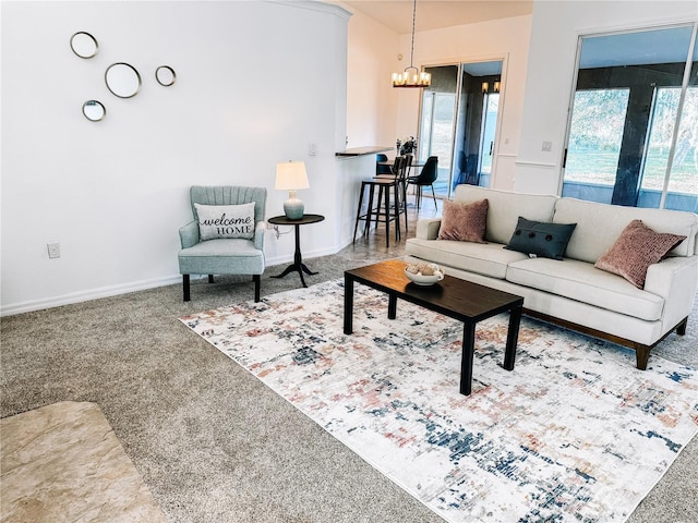 living room with carpet and a notable chandelier