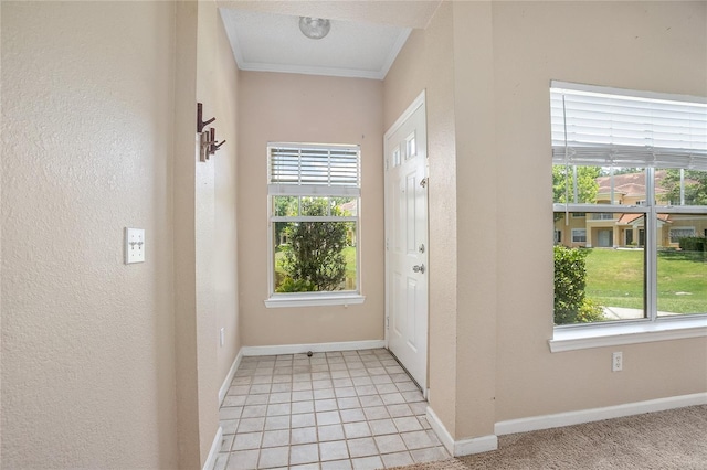 doorway with a textured ceiling, crown molding, light tile patterned floors, and a wealth of natural light