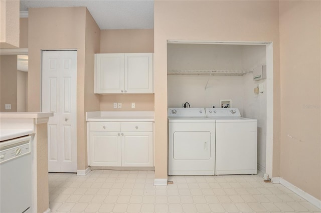 laundry room with a textured ceiling and washer and clothes dryer