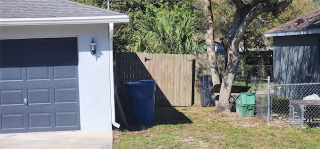 exterior space featuring a garage and fence