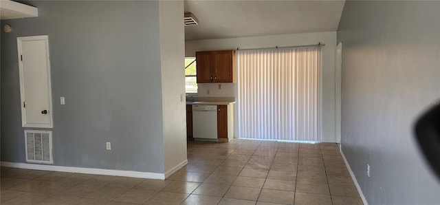 spare room with light tile patterned floors, baseboards, and visible vents