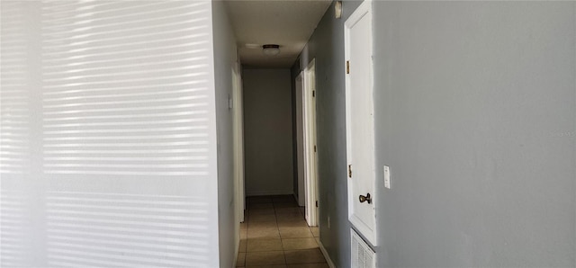 corridor featuring tile patterned flooring and visible vents