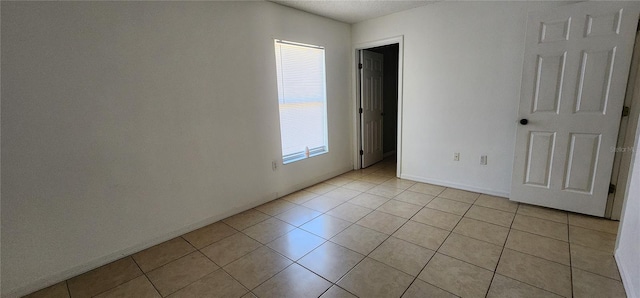 spare room with light tile patterned flooring