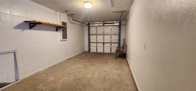 garage with concrete block wall and electric panel