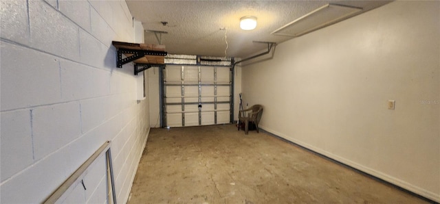 garage featuring concrete block wall and baseboards