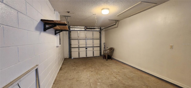 garage with concrete block wall and baseboards