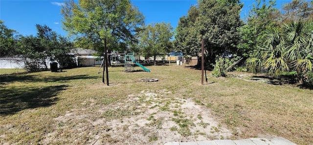 view of yard with playground community and a fenced backyard