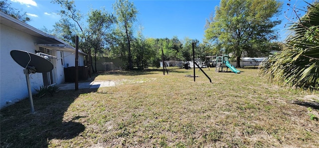 view of yard featuring a playground and fence