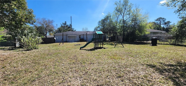 view of yard with fence and a playground