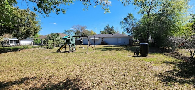 view of yard with a playground and fence