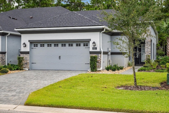 view of front facade featuring a garage and a front lawn