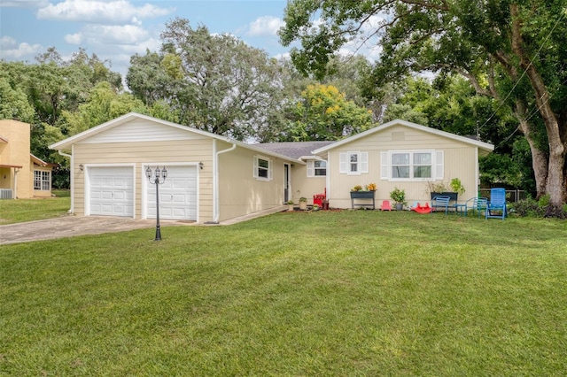 ranch-style house featuring a garage and a front lawn