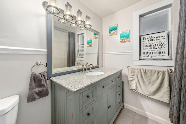 bathroom with vanity, toilet, and tile patterned floors