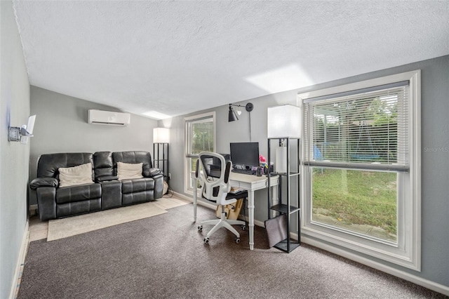 home office with a textured ceiling, a healthy amount of sunlight, carpet, and a wall mounted air conditioner