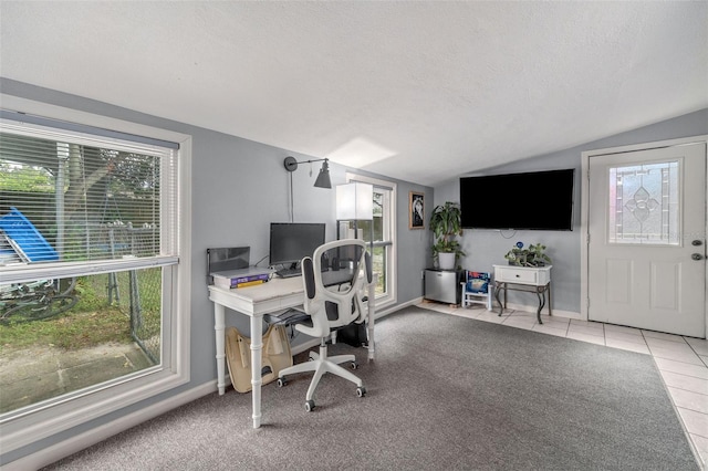 tiled home office featuring a textured ceiling and lofted ceiling