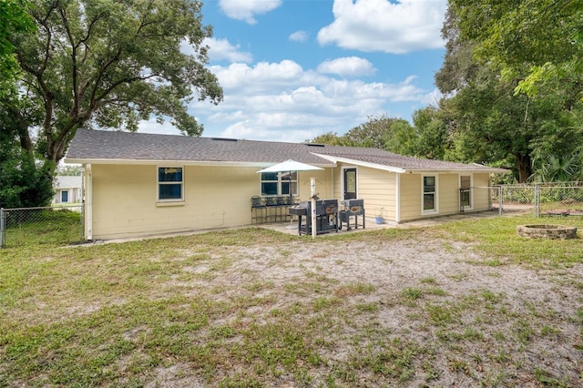 back of property featuring a lawn and a patio area