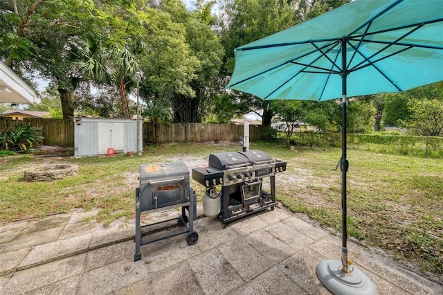 view of patio featuring a storage shed and a grill