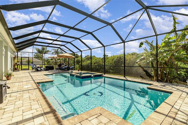 view of swimming pool with glass enclosure, an in ground hot tub, and a patio area