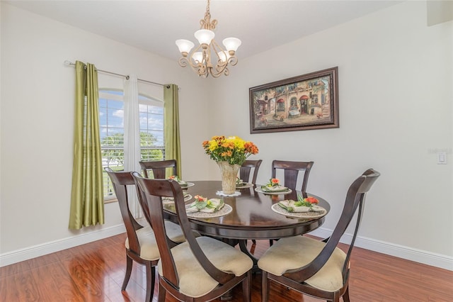 929 Hialeah St, Rockledge, FL 32955 - dining space with baseboards, wood finished floors, and a notable chandelier