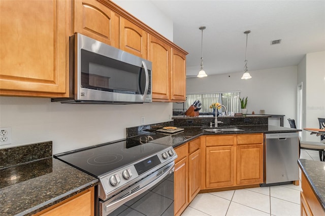 929 Hialeah St, Rockledge, FL 32955 - kitchen featuring visible vents, a sink, light tile patterned flooring, a peninsula, and appliances with stainless steel finishes