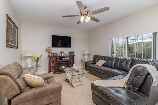 929 Hialeah St, Rockledge, FL 32955 - living area with a ceiling fan, baseboards, light tile patterned flooring, and a lit fireplace