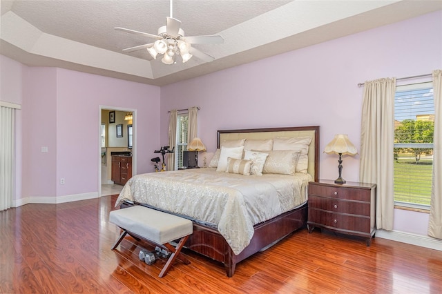929 Hialeah St, Rockledge, FL 32955 - bedroom with a raised ceiling, wood finished floors, a textured ceiling, and baseboards