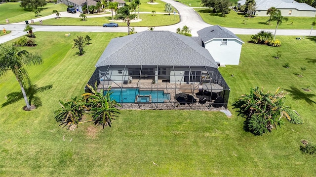 929 Hialeah St, Rockledge, FL 32955 - rear view of property featuring glass enclosure, a patio area, a lawn, and an outdoor pool