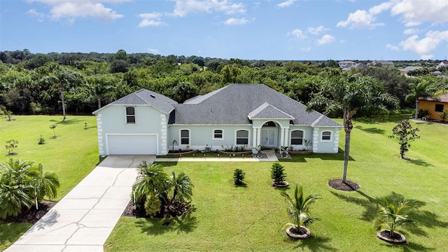 view of front of property featuring a front lawn and a garage