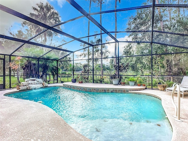 view of pool with a patio area and a lanai