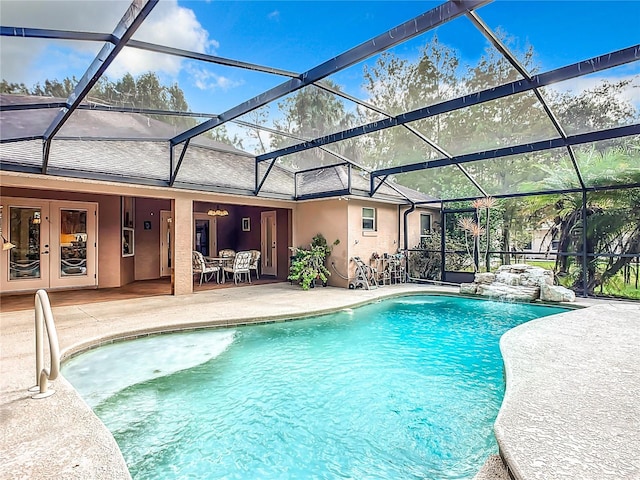 view of swimming pool with glass enclosure and a patio area