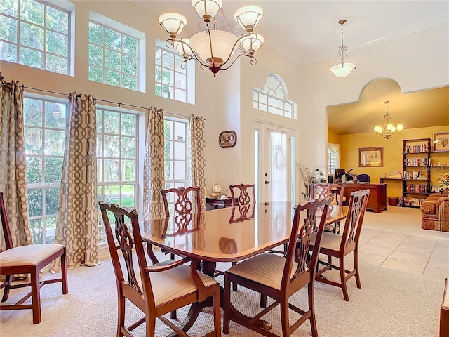 dining space with a wealth of natural light, light tile patterned floors, a chandelier, and ornamental molding