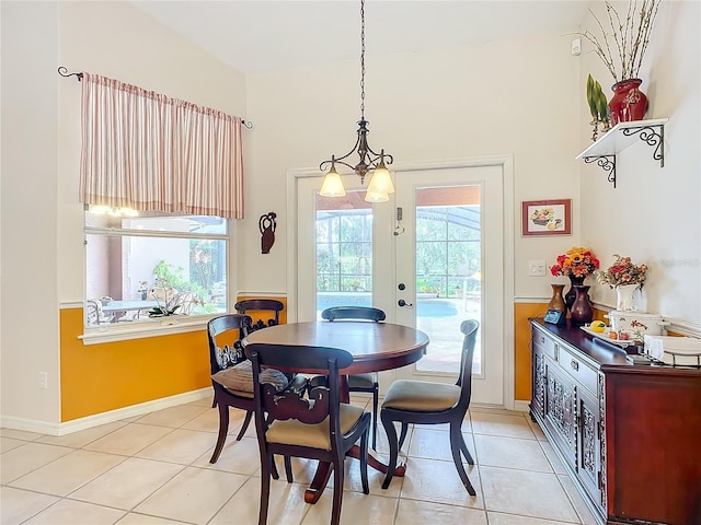 tiled dining room featuring a notable chandelier