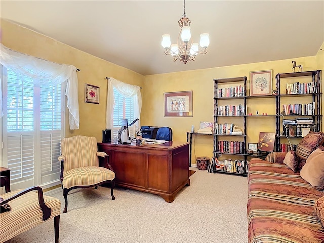 home office featuring a notable chandelier, a healthy amount of sunlight, and carpet floors