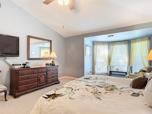 bedroom featuring ceiling fan, light carpet, and vaulted ceiling