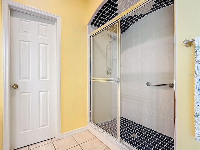 bathroom with tile patterned floors and walk in shower