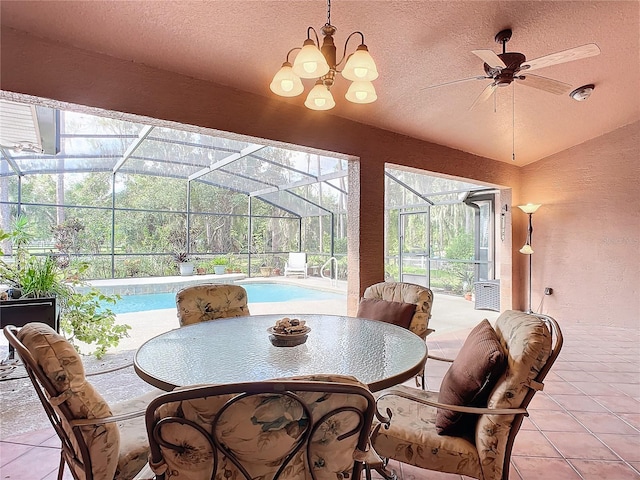 interior space featuring a wealth of natural light, a swimming pool, and ceiling fan with notable chandelier