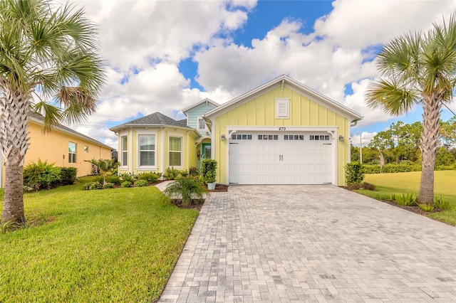 view of front of property with a front lawn and a garage