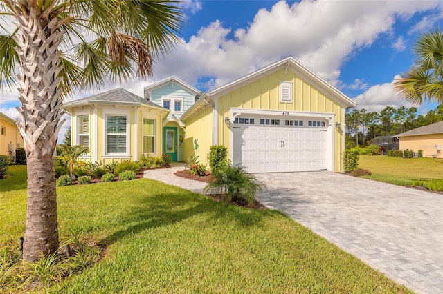 view of front of property featuring a garage and a front yard