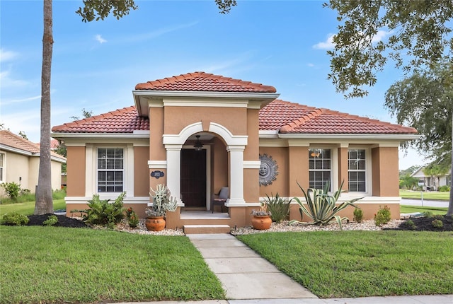 mediterranean / spanish home with a front yard