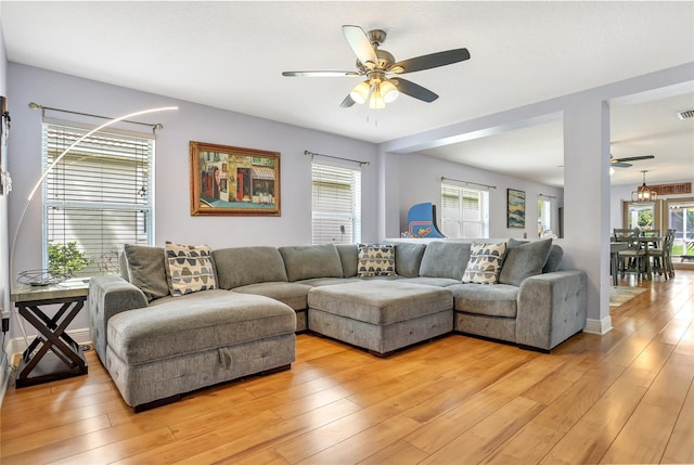 living room with light wood-type flooring and ceiling fan