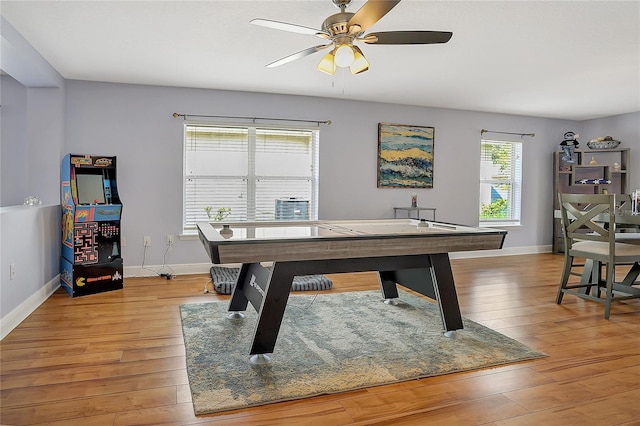 recreation room featuring a wealth of natural light, ceiling fan, and light wood-type flooring