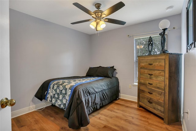 bedroom with ceiling fan and hardwood / wood-style flooring