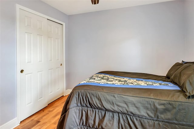 bedroom with wood-type flooring and a closet