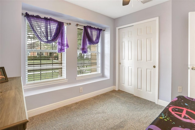 interior space featuring a healthy amount of sunlight, carpet flooring, and ceiling fan