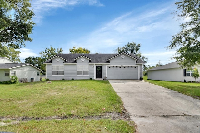 ranch-style home featuring a garage and a front yard